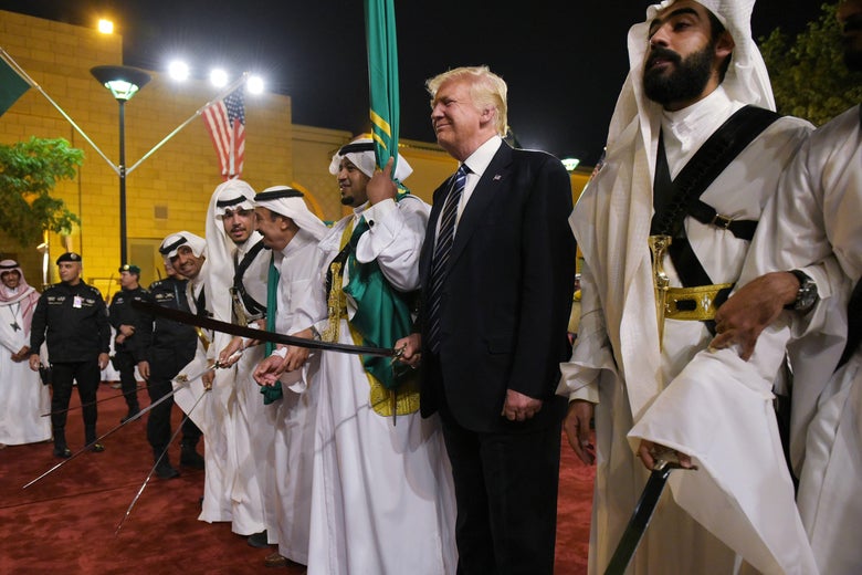 U.S. President Donald Trump joins dancers with swords at a welcome ceremony ahead of a banquet at the Murabba Palace in Riyadh on May 20, 2017.